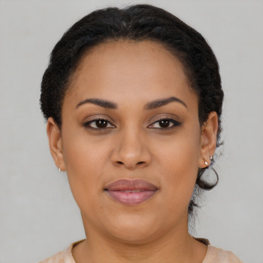 Joyful black young-adult female with short  brown hair and brown eyes