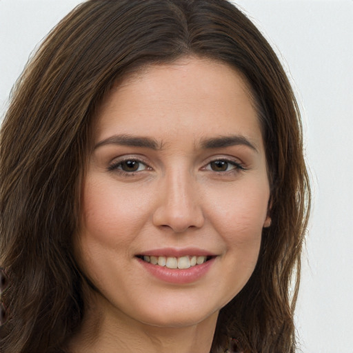 Joyful white young-adult female with long  brown hair and brown eyes