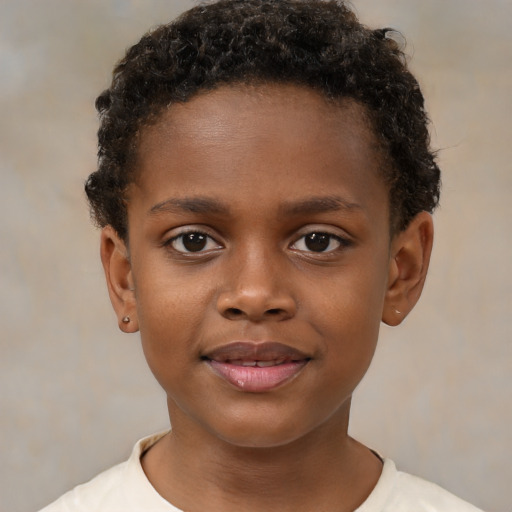 Joyful black child male with short  brown hair and brown eyes