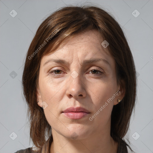 Joyful white adult female with medium  brown hair and grey eyes