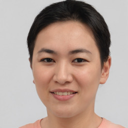 Joyful asian young-adult female with short  brown hair and brown eyes