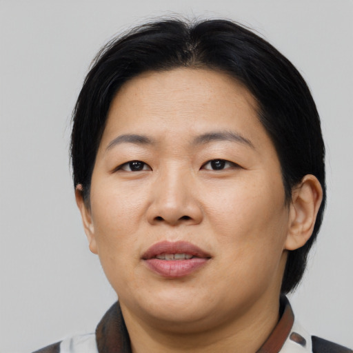 Joyful asian adult female with short  black hair and brown eyes