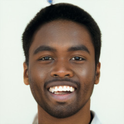 Joyful black young-adult male with short  brown hair and brown eyes