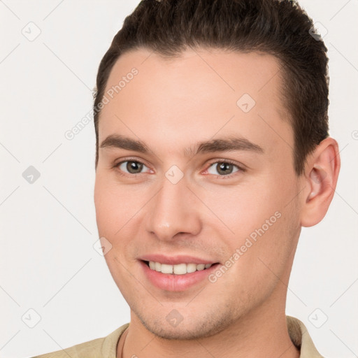 Joyful white young-adult male with short  brown hair and brown eyes