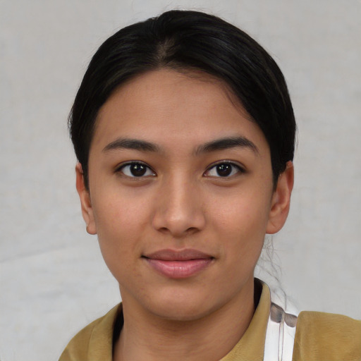 Joyful asian young-adult female with short  brown hair and brown eyes