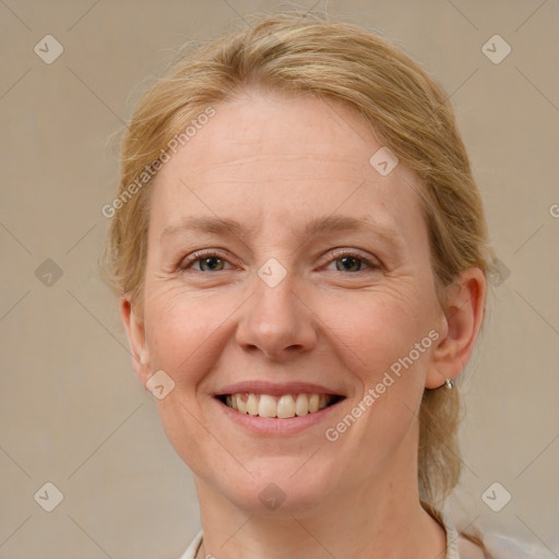 Joyful white adult female with medium  brown hair and blue eyes