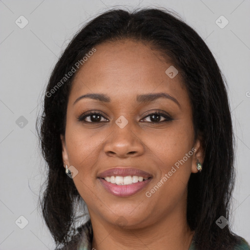 Joyful black young-adult female with long  brown hair and brown eyes