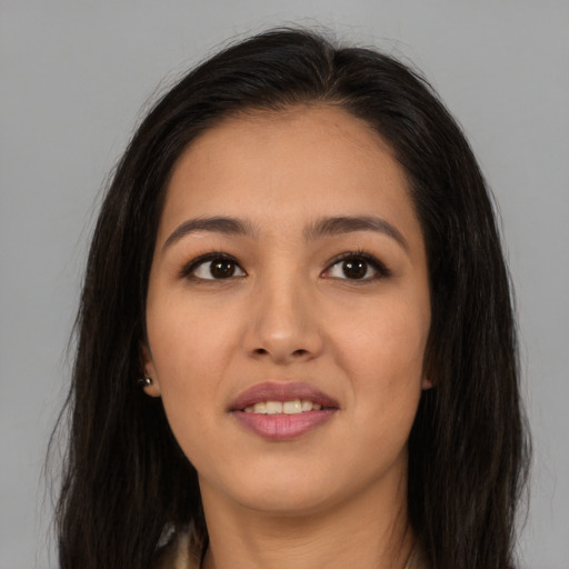 Joyful asian young-adult female with long  brown hair and brown eyes