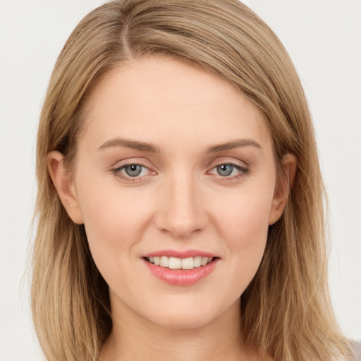 Joyful white young-adult female with long  brown hair and green eyes