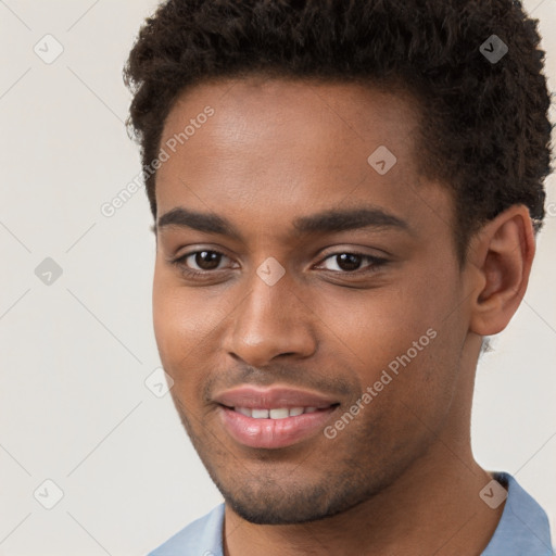 Joyful black young-adult male with short  brown hair and brown eyes