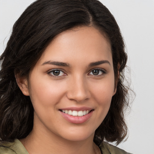 Joyful white young-adult female with medium  brown hair and brown eyes