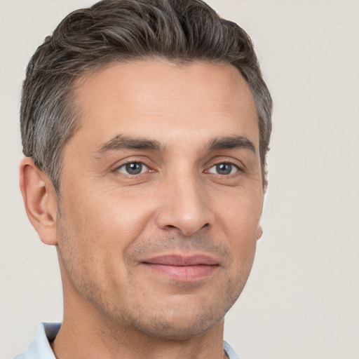 Joyful white adult male with short  brown hair and brown eyes