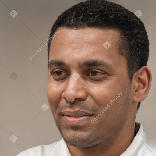 Joyful latino adult male with short  black hair and brown eyes