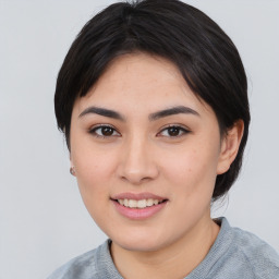 Joyful asian young-adult female with medium  black hair and brown eyes