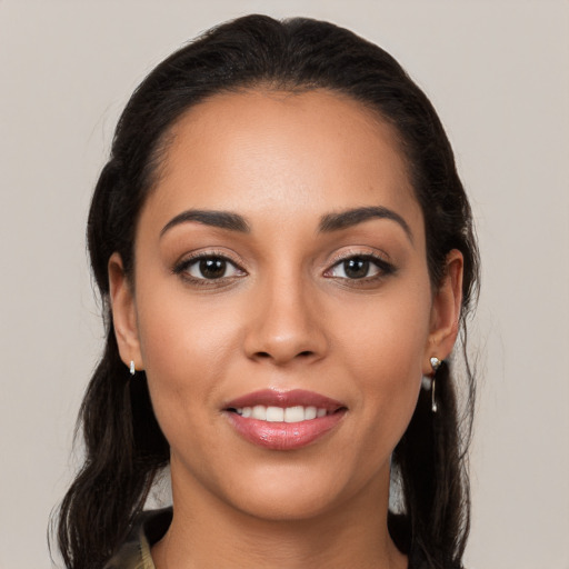 Joyful latino young-adult female with long  brown hair and brown eyes