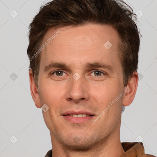 Joyful white adult male with short  brown hair and grey eyes