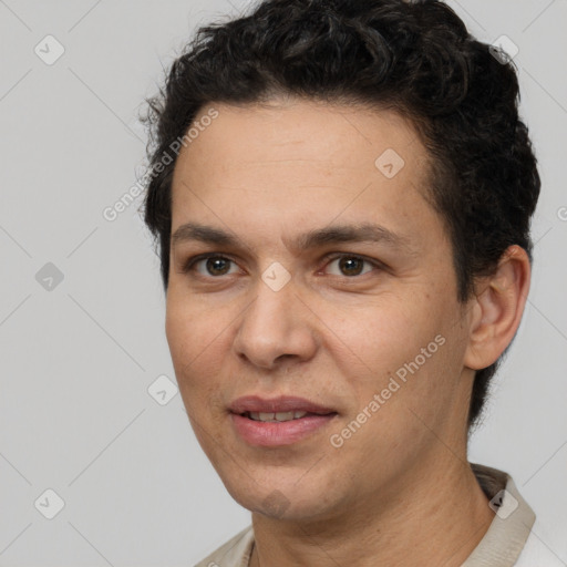 Joyful white adult male with short  black hair and brown eyes