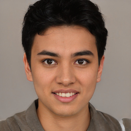 Joyful latino young-adult male with short  brown hair and brown eyes
