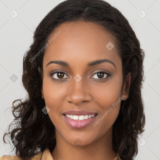 Joyful black young-adult female with long  brown hair and brown eyes