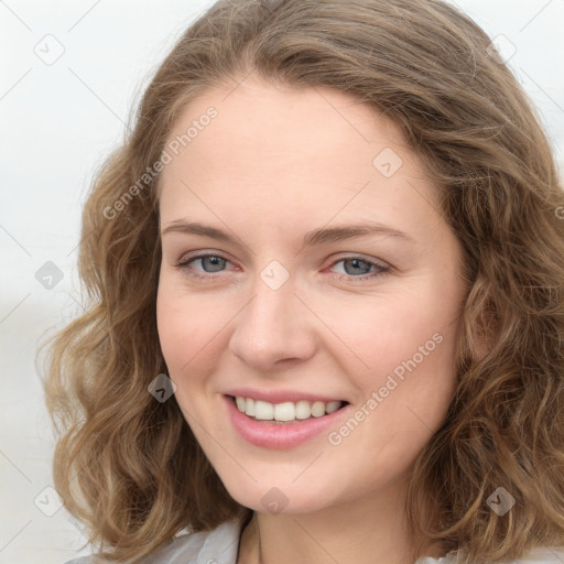 Joyful white young-adult female with long  brown hair and blue eyes