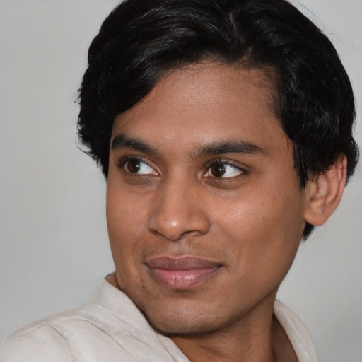 Joyful asian young-adult male with short  black hair and brown eyes