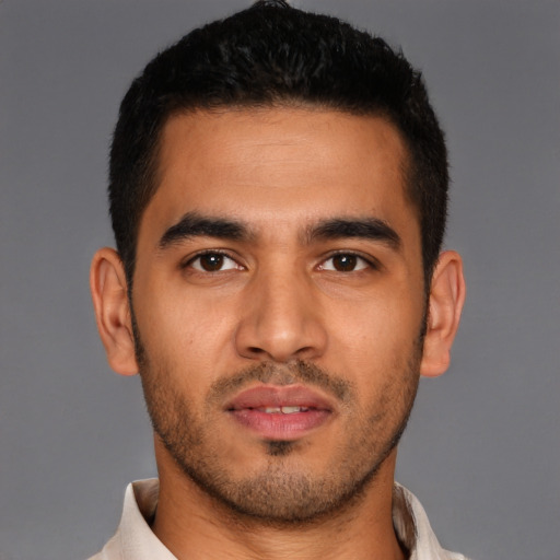 Joyful latino young-adult male with short  brown hair and brown eyes