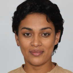 Joyful latino young-adult female with short  black hair and brown eyes