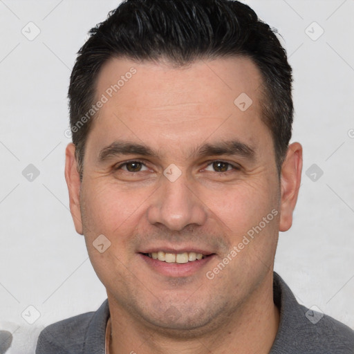 Joyful white adult male with short  brown hair and brown eyes