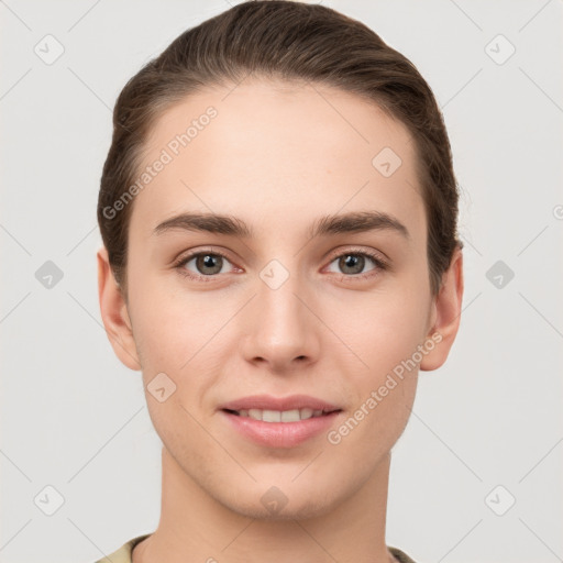 Joyful white young-adult female with short  brown hair and grey eyes