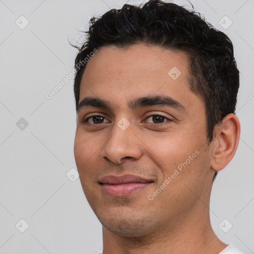 Joyful white young-adult male with short  black hair and brown eyes