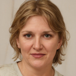 Joyful white adult female with medium  brown hair and grey eyes