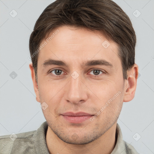 Joyful white young-adult male with short  brown hair and brown eyes