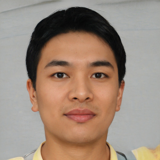 Joyful asian young-adult male with short  black hair and brown eyes