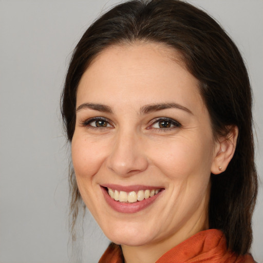 Joyful white adult female with medium  brown hair and brown eyes