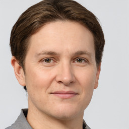 Joyful white adult male with short  brown hair and grey eyes