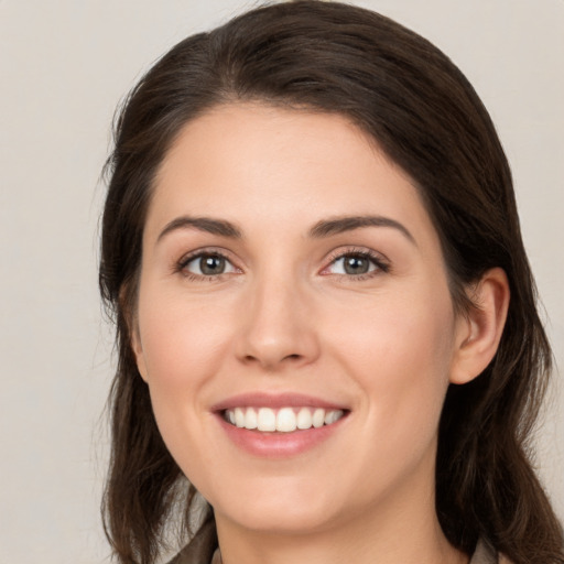 Joyful white young-adult female with medium  brown hair and brown eyes