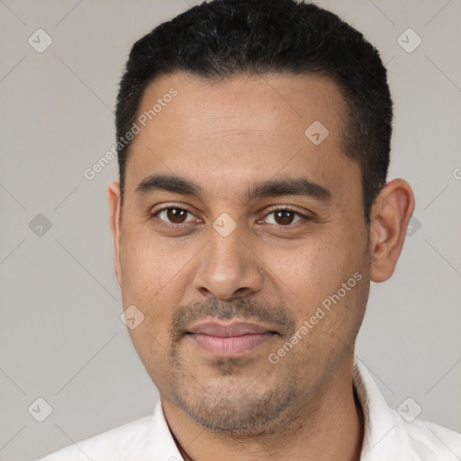 Joyful latino young-adult male with short  black hair and brown eyes