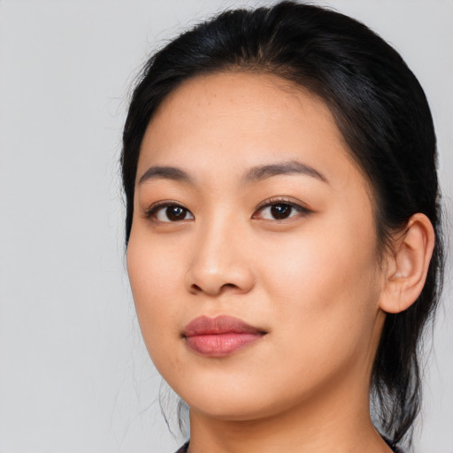 Joyful asian young-adult female with long  black hair and brown eyes