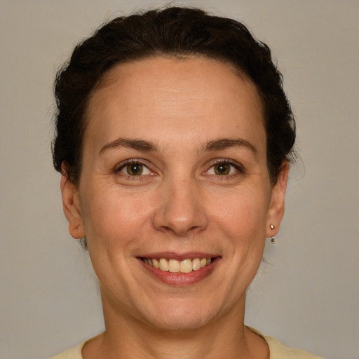 Joyful white adult female with short  brown hair and brown eyes