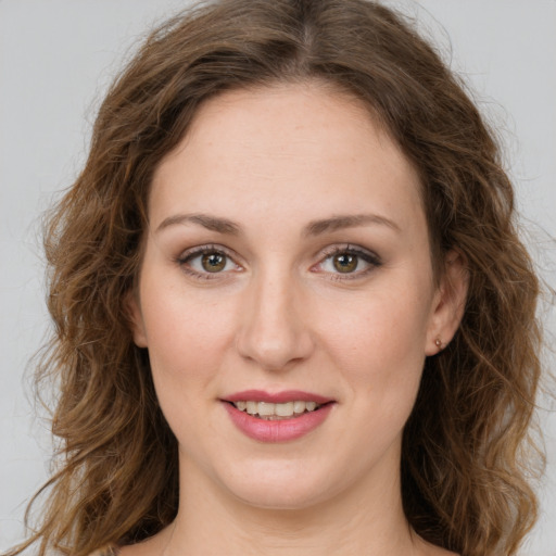 Joyful white young-adult female with long  brown hair and green eyes