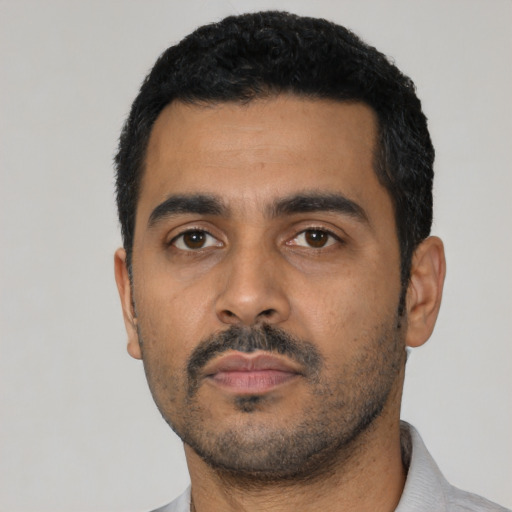 Neutral latino young-adult male with short  black hair and brown eyes