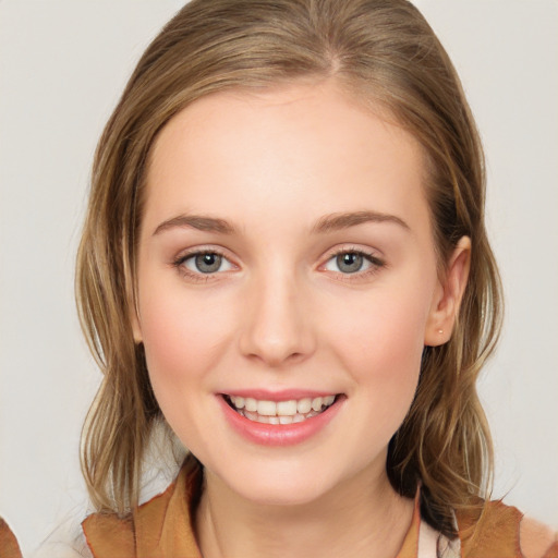 Joyful white young-adult female with medium  brown hair and blue eyes