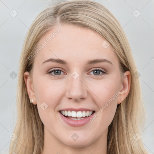 Joyful white young-adult female with long  brown hair and blue eyes