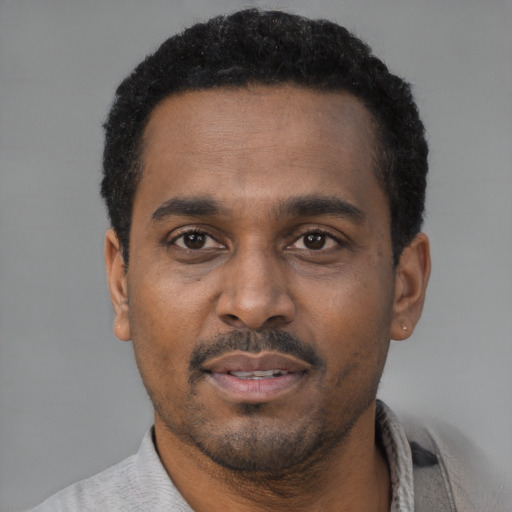 Neutral latino adult male with short  black hair and brown eyes
