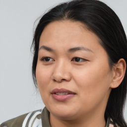 Joyful asian young-adult female with medium  brown hair and brown eyes