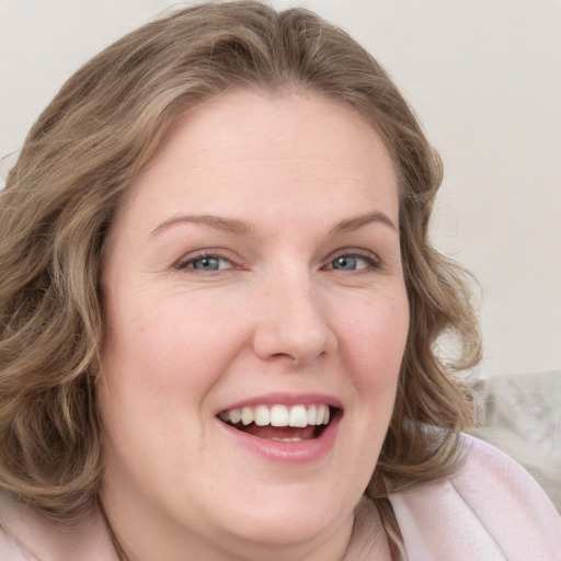 Joyful white young-adult female with medium  brown hair and green eyes