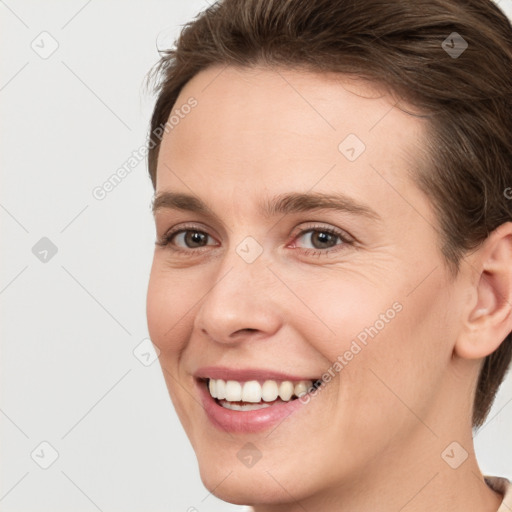 Joyful white young-adult female with short  brown hair and grey eyes