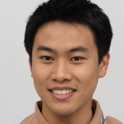 Joyful asian young-adult male with short  brown hair and brown eyes