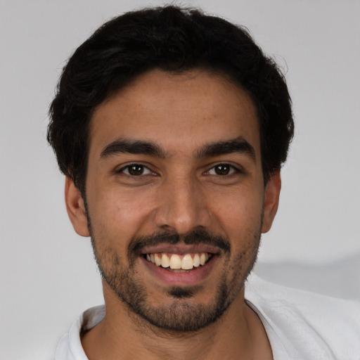 Joyful white young-adult male with short  black hair and brown eyes