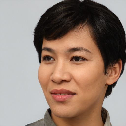 Joyful asian young-adult female with short  black hair and brown eyes